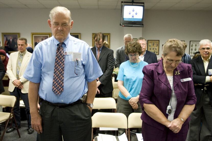  Anthony Bruner and Mary Lou Bruner pray at the start of a meeting in Austin of the Texas...