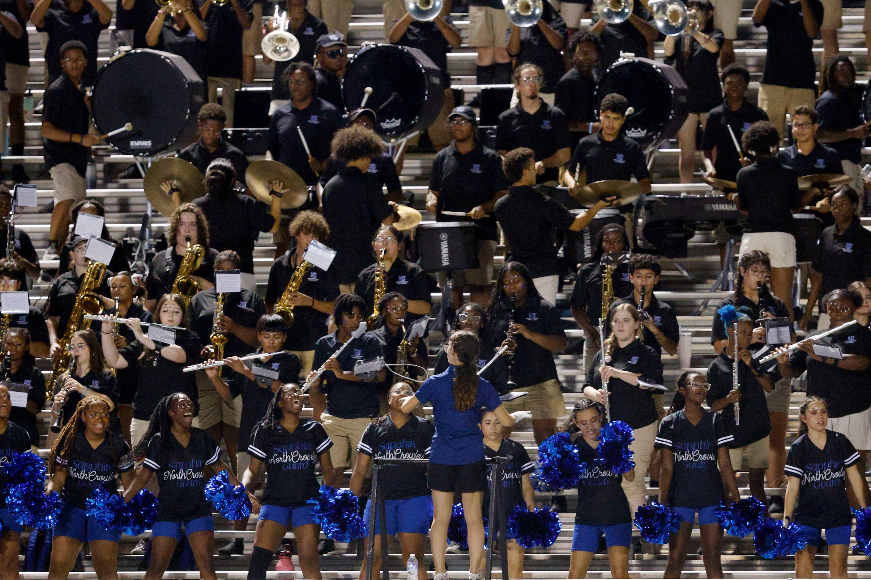 North Crowley’s marching band performs during the second half of a high school football game...