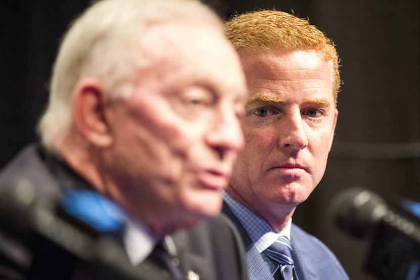 Dallas Cowboys head coach Jason Garrett listens as owner Jerry Jones discuss the team's...