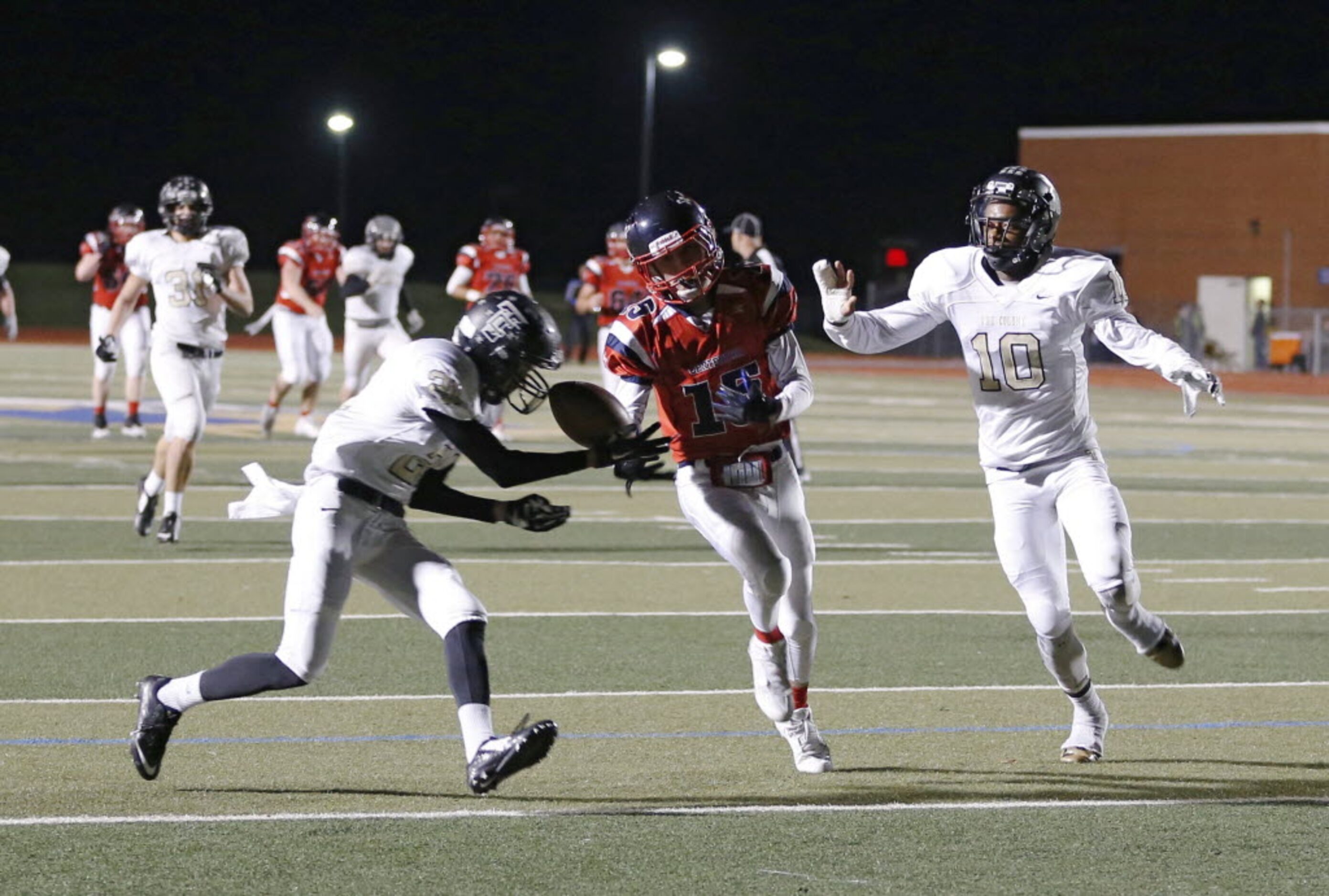 Frisco Centennial's Adam Hoffman (15) can't make the catch as The Colony's Jalen Brown (21)...