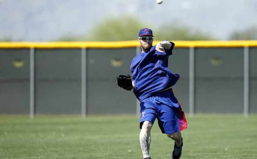 Josh Hamilton plays catch during workouts at Surprise Stadium on April 28, 2015. (Rick...