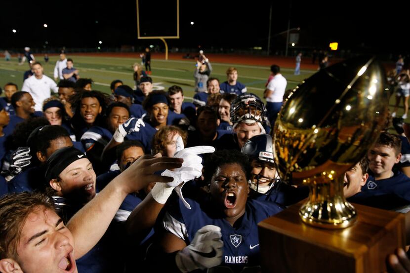 Frisco Lone Star celebrates as they receive the 13-5A district trophy after defeating Frisco...