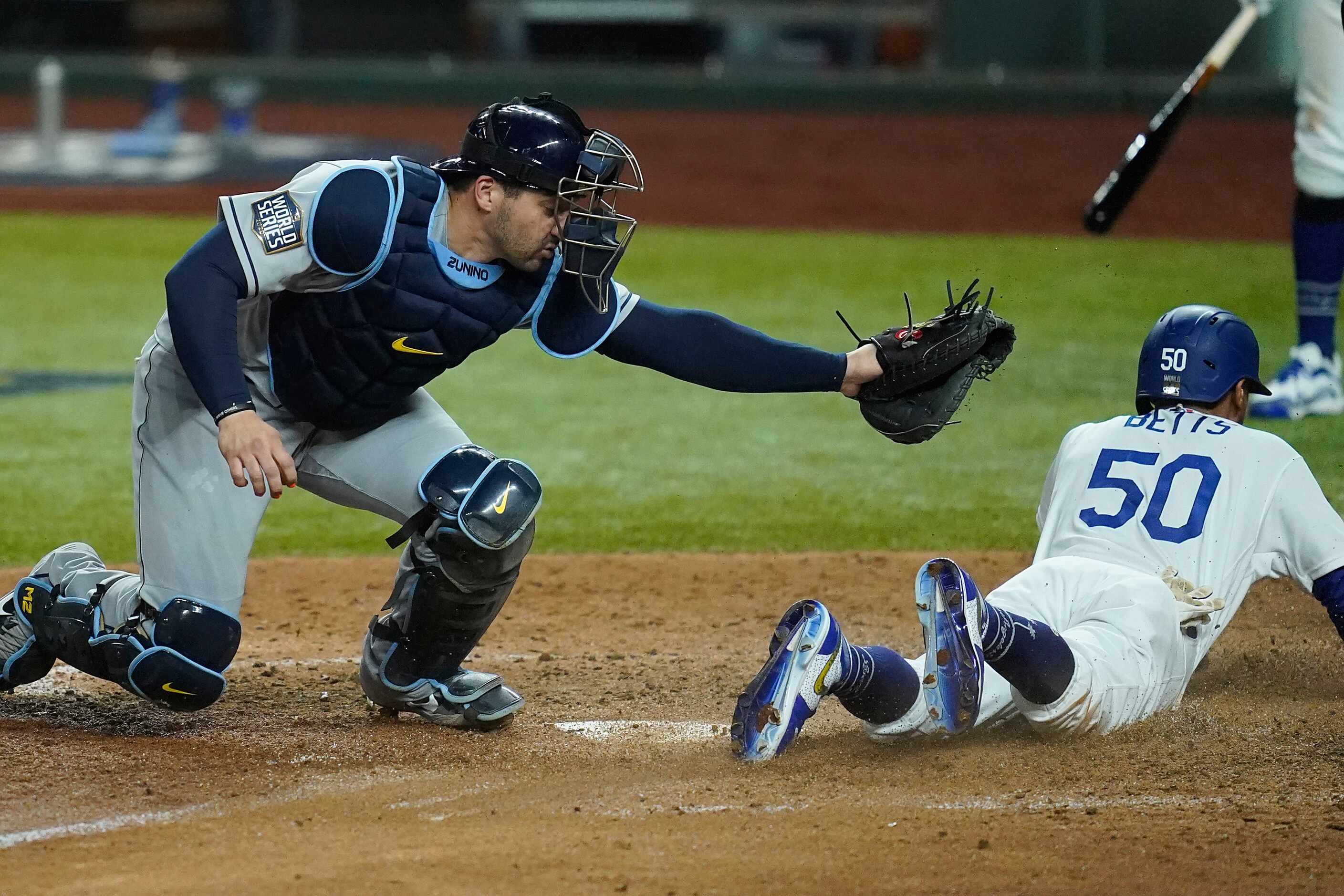 Los Angeles Dodgers right fielder Mookie Betts (50) scores past Tampa Bay Rays catcher Mike...