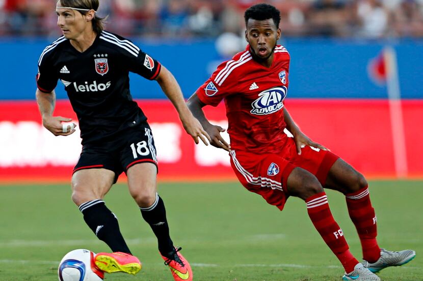 D.C. United forward Chris Rolfe (18) steals the ball from FC Dallas defender/midfielder...
