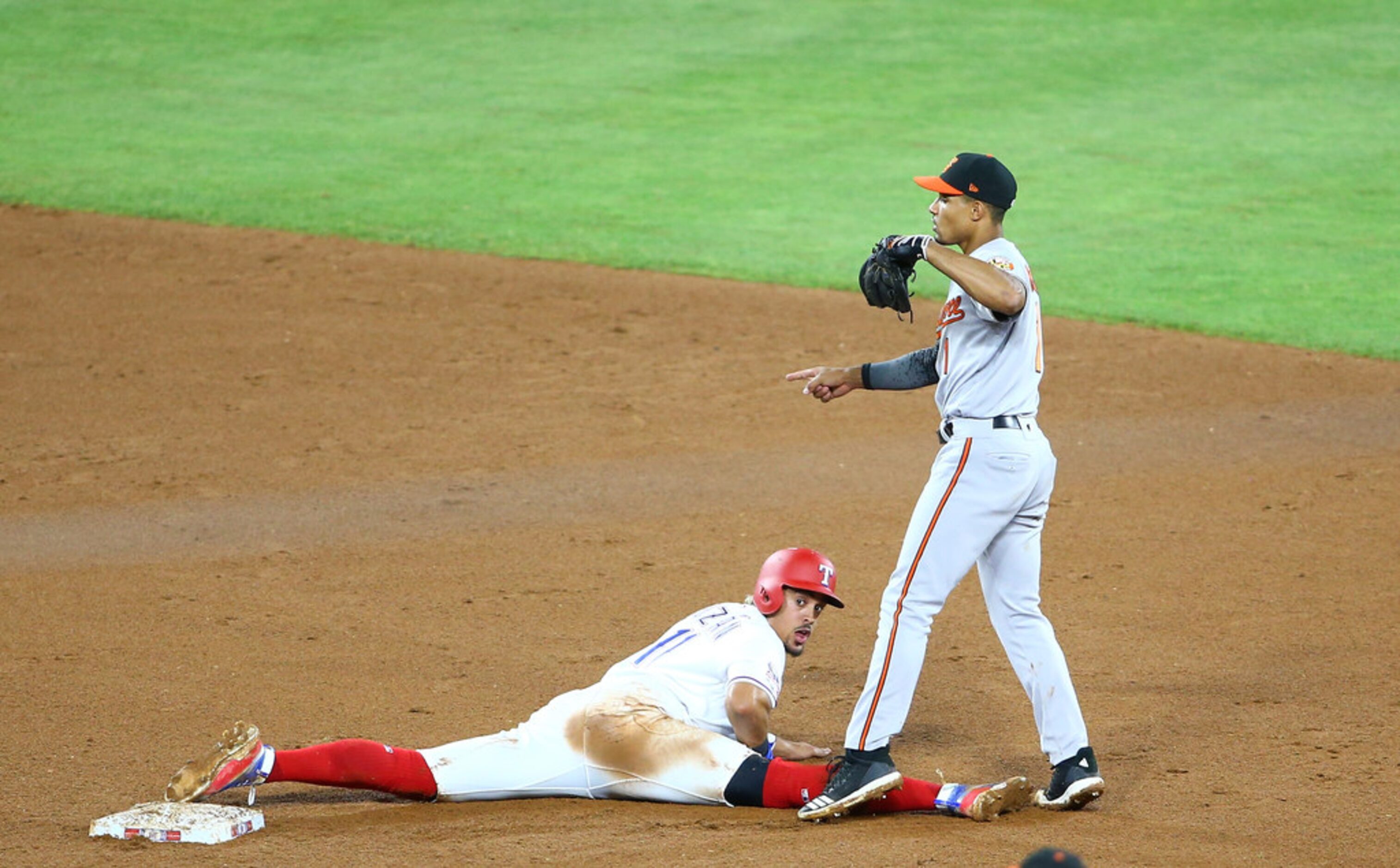 ARLINGTON, TX - JUNE 06: Ronald Guzman #11 of the Texas Rangers tagged out by Richie Martin...