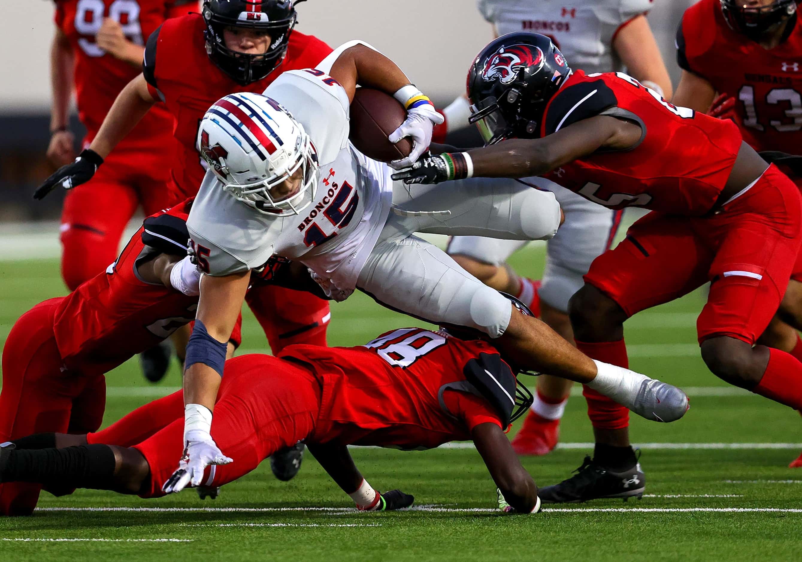 McKinney Boyd running back Carter Whitefield (15) gets tripped up by Denton Braswell...