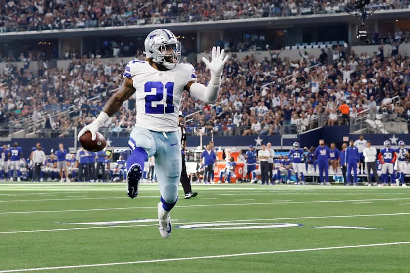 With his tongue hanging out, Dallas Cowboys running back Ezekiel Elliott (21) high steps...
