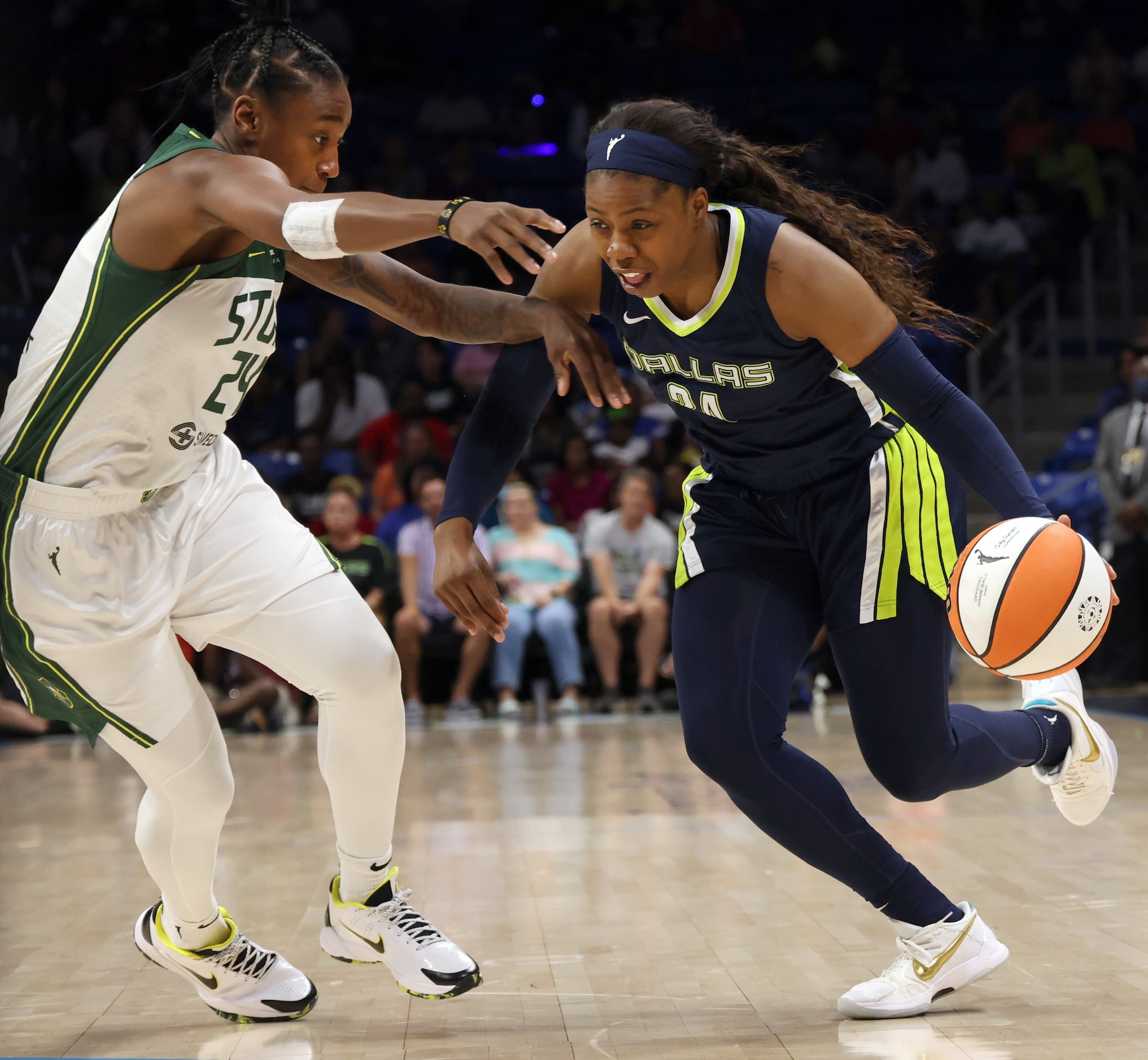 Dallas Wings guard Arike Ogunbowale (24) drives against the defense of Seattle Storm guard...