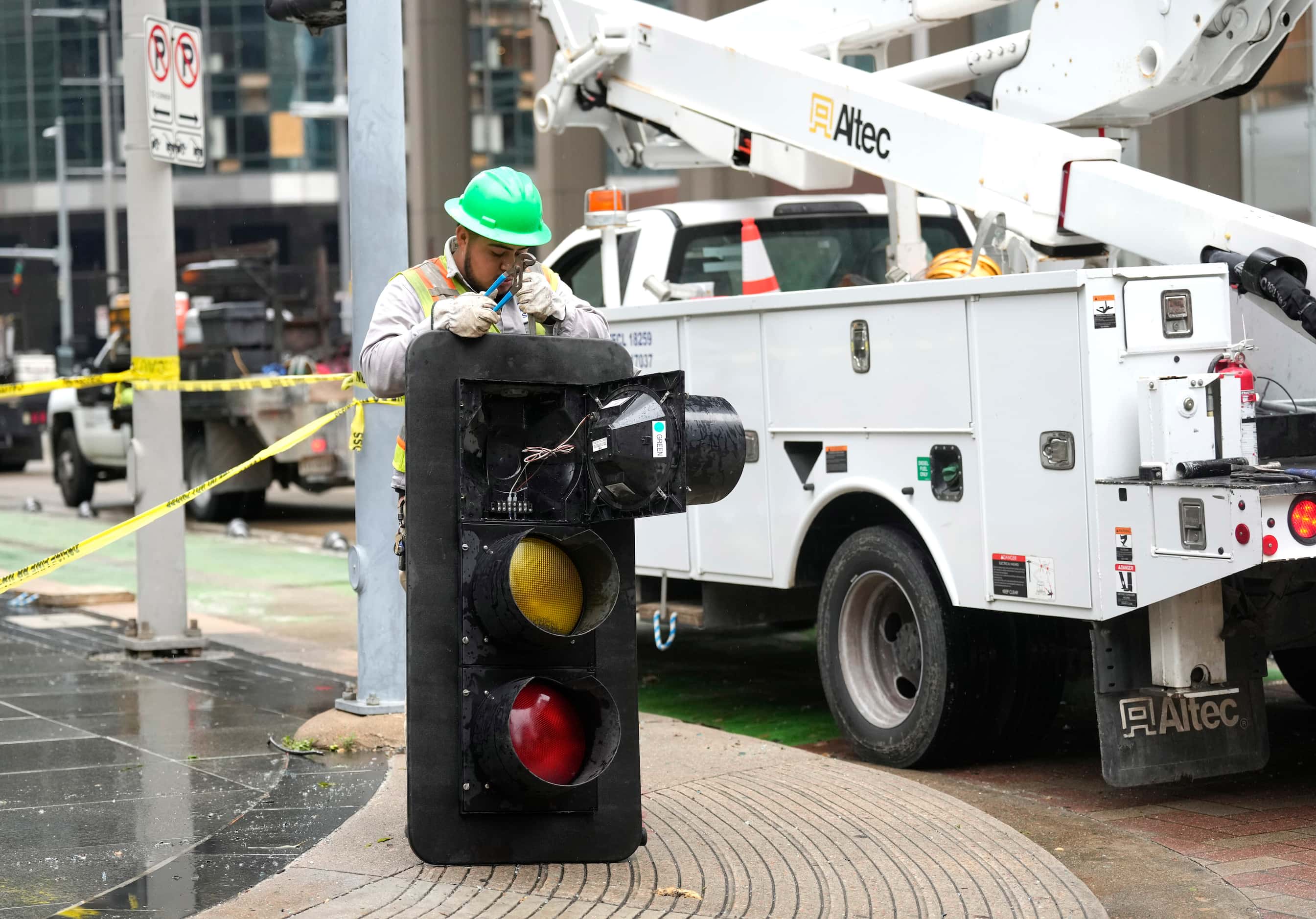 A worker works on a street light that was damaged downtown on Friday, May 17, 2024, in...