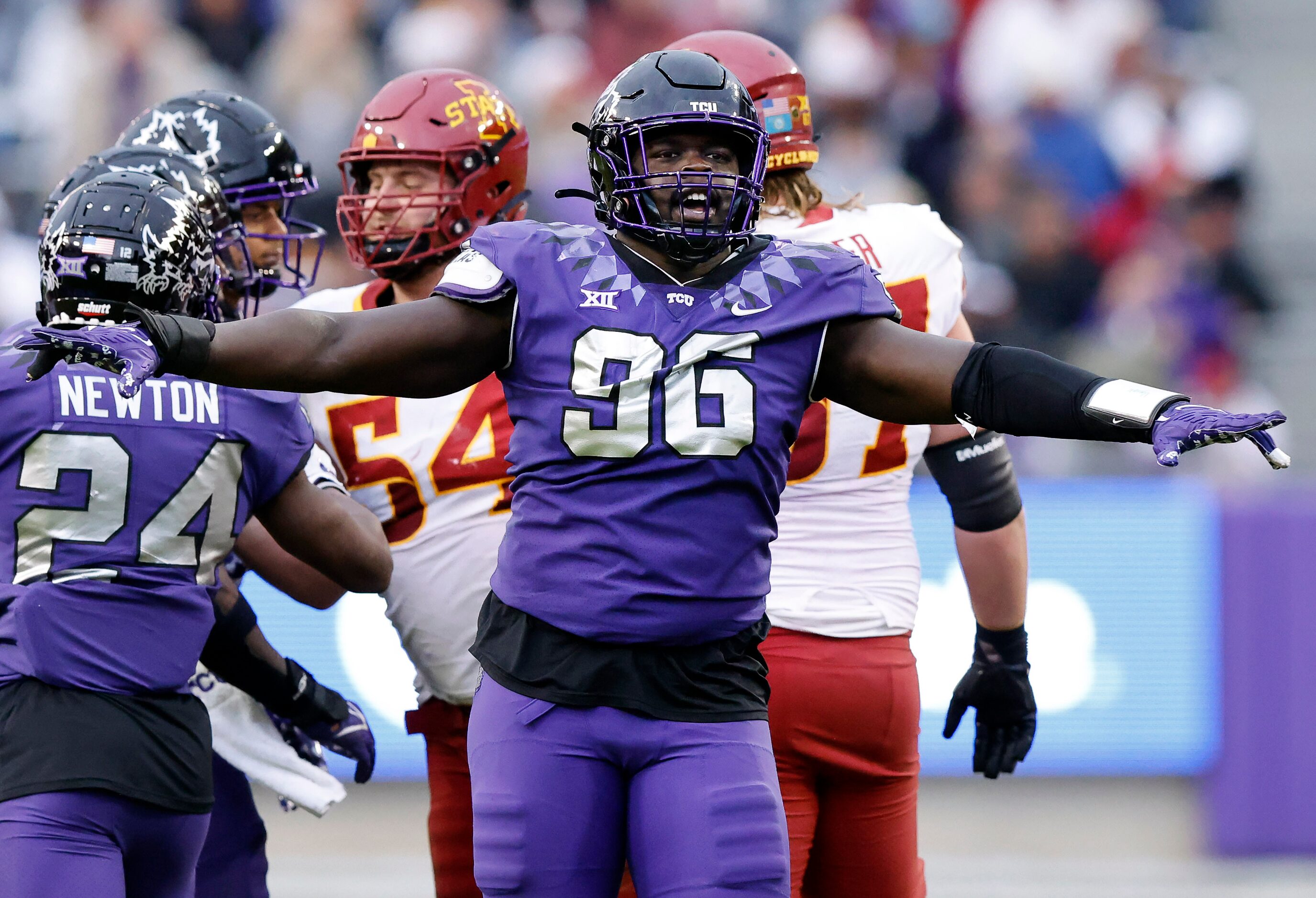 TCU Horned Frogs defensive lineman Lwal Uguak (96) celebrates a first half stop of the Iowa...