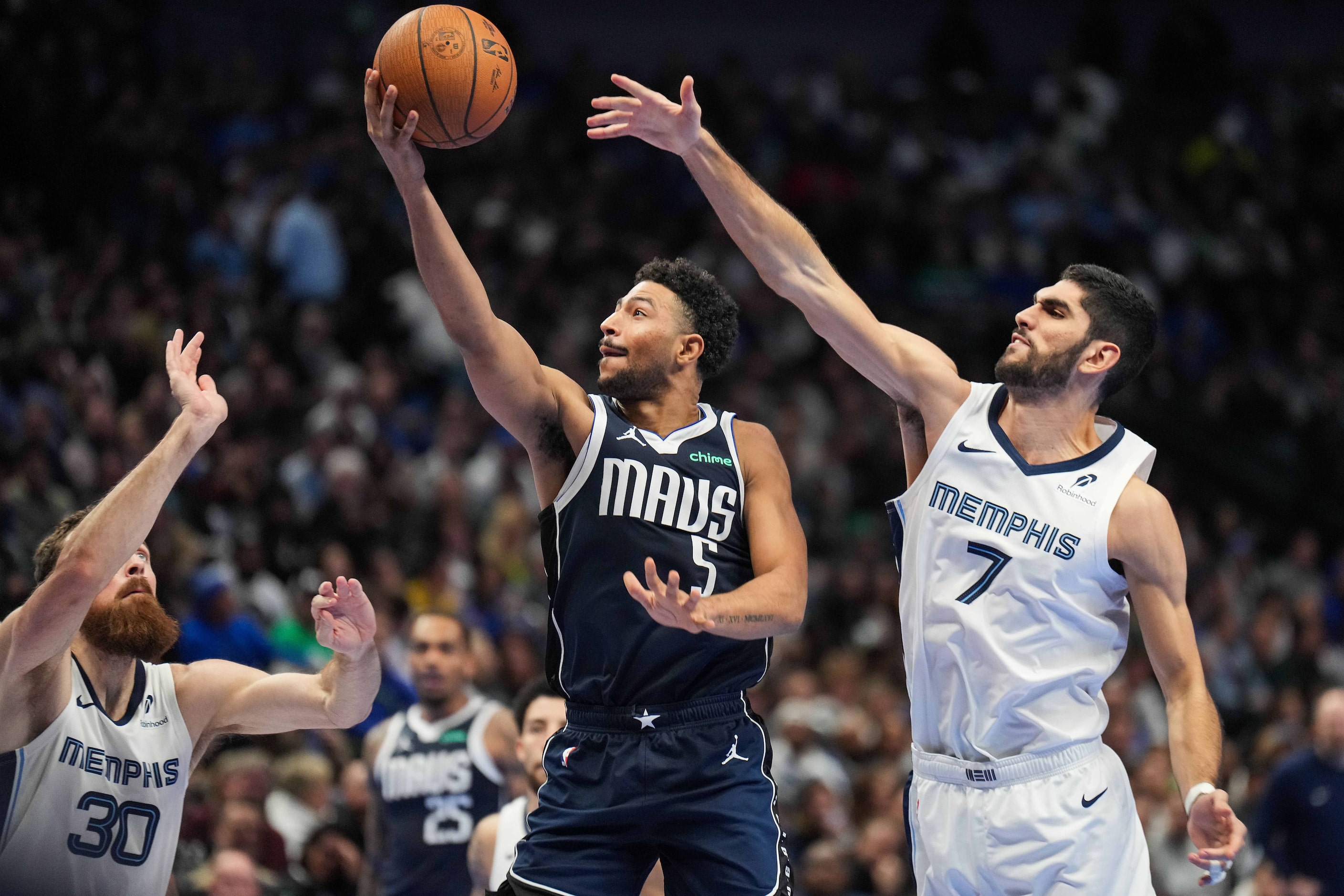 Dallas Mavericks guard Quentin Grimes (5) goes for a layup past Memphis Grizzlies forward...