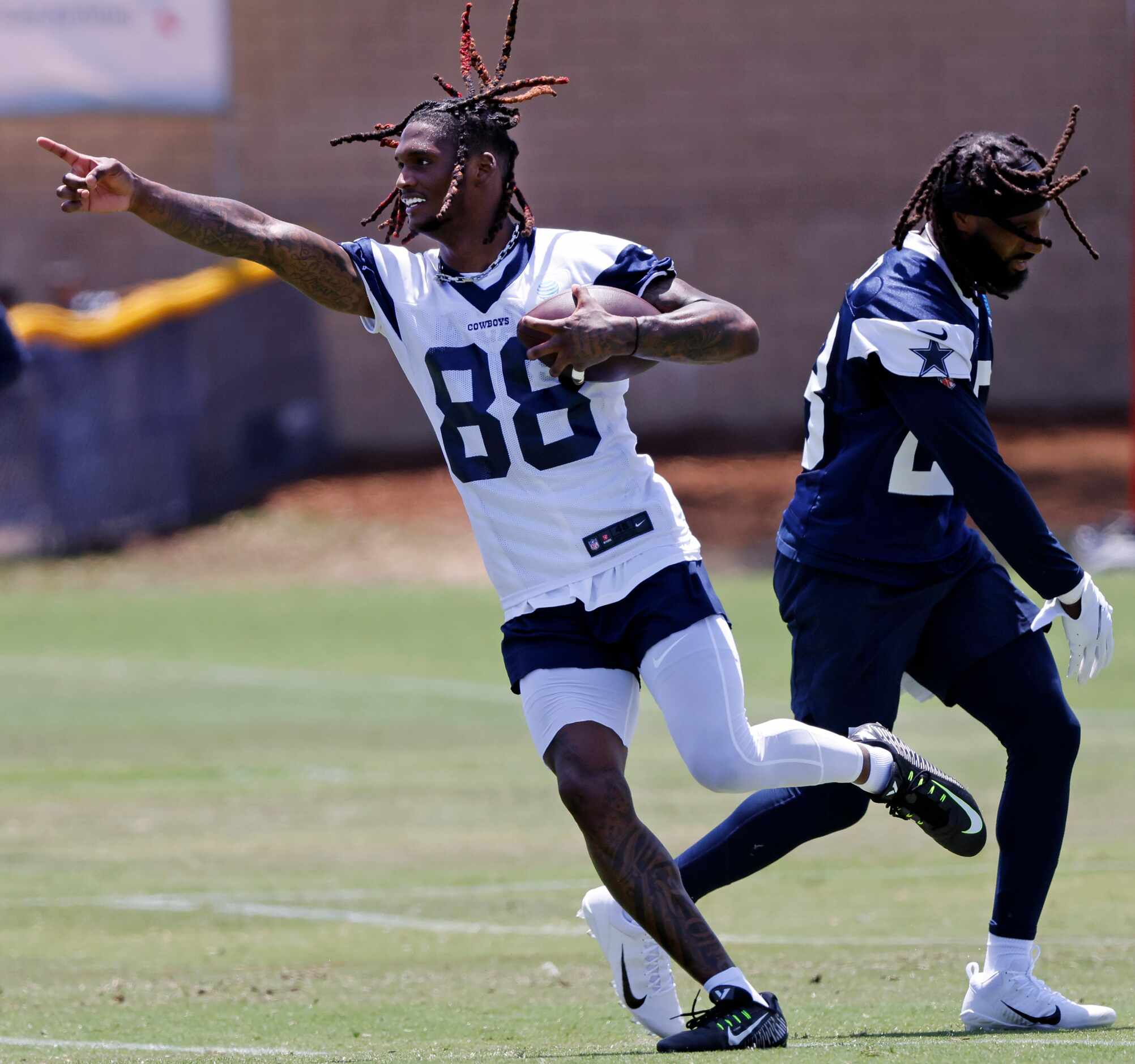 Dallas Cowboys wide receiver CeeDee Lamb (88) points downfield after making a catch and...