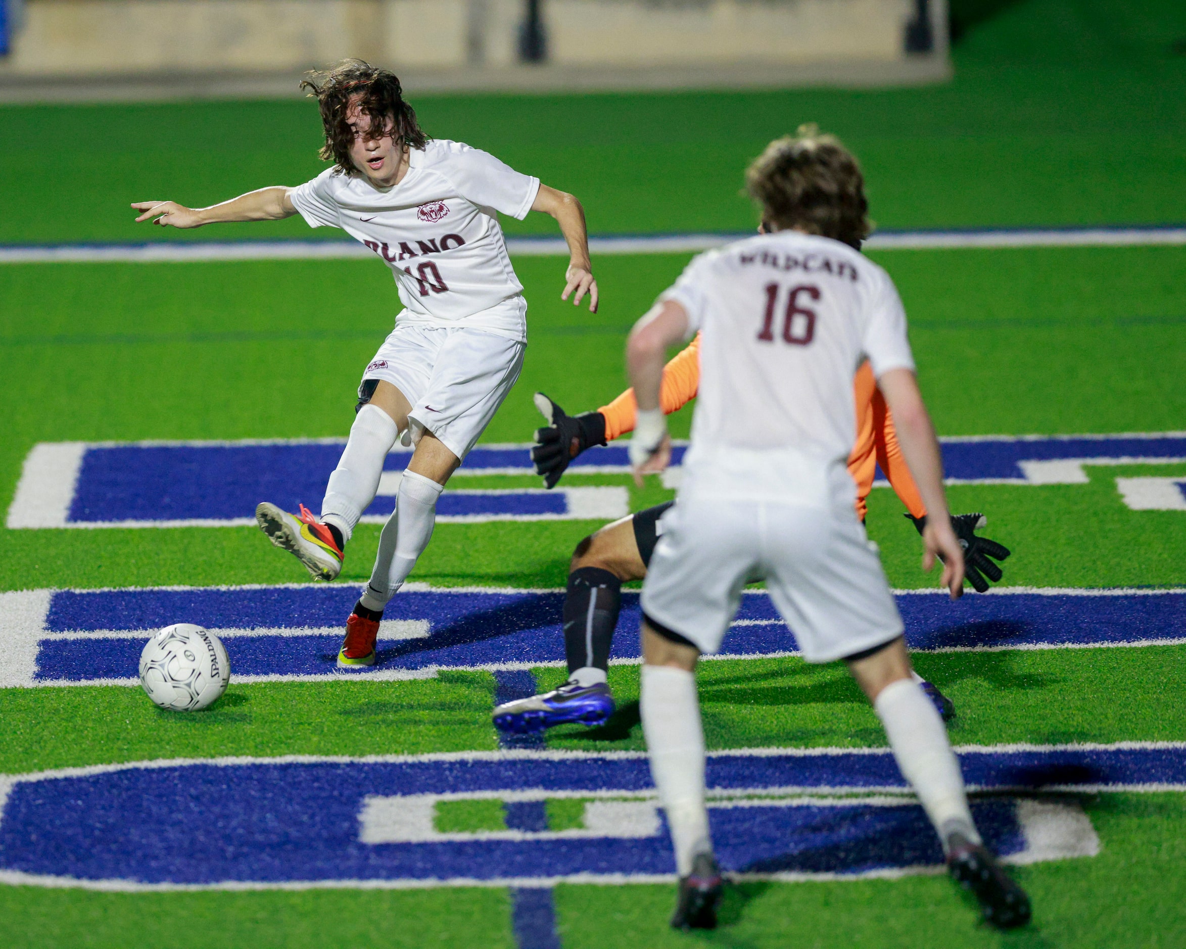 Plano midfielder Michael Rogers (10) passes the ball to Plano forward Nolan Giles (16) for a...