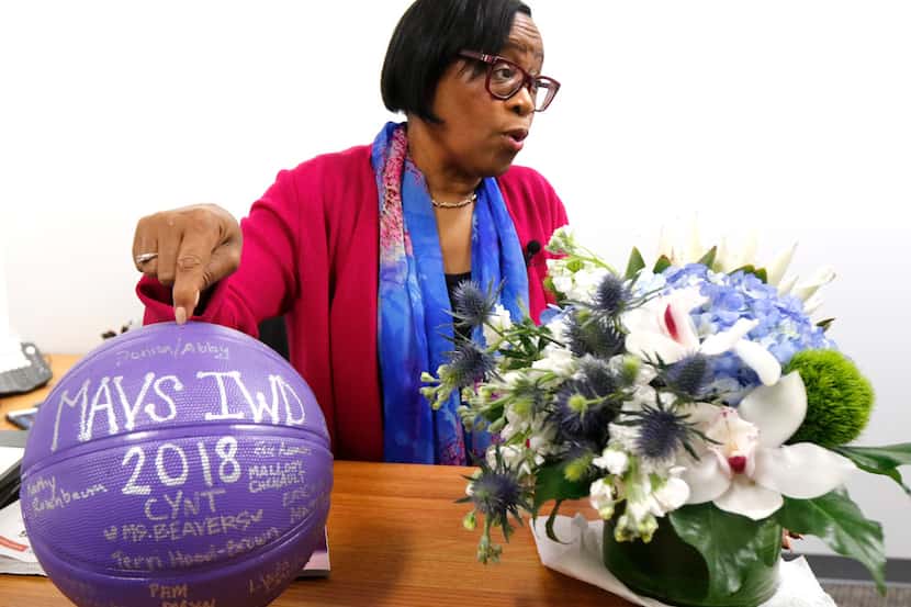 Dallas Mavericks interim CEO Cynt Marshall points to a basketball in her new office that was...