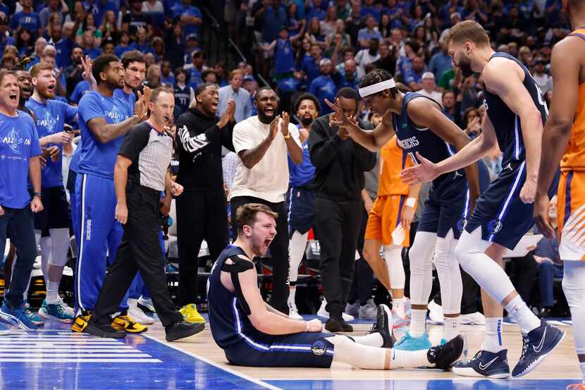 Dallas Mavericks guard Luka Doncic (77) and the rest of the bench react after he was fouled...