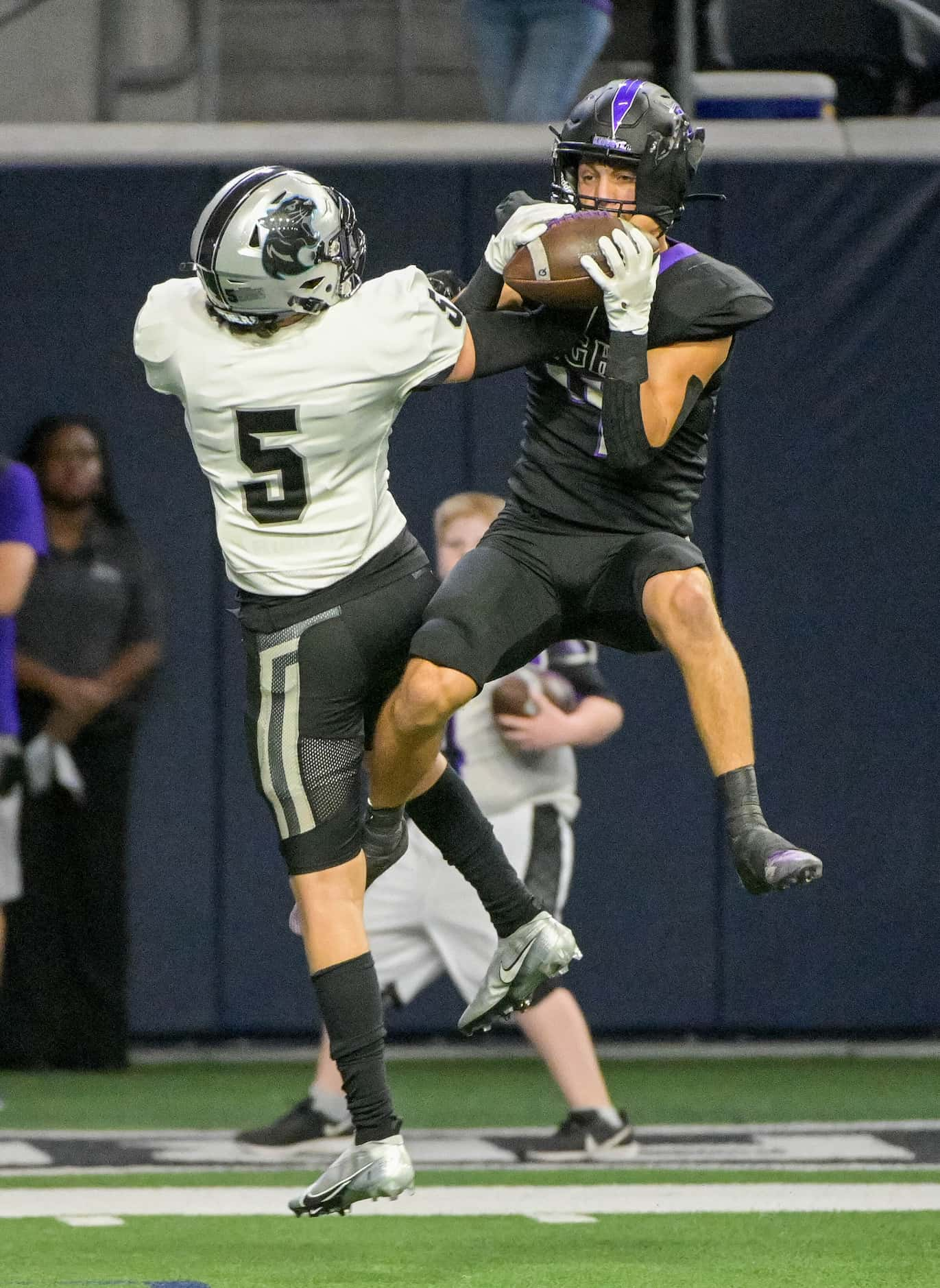 Independence’s Landon Neeley (4) catches a pass over Panther Creek’s Canyen Wong (5) in the...