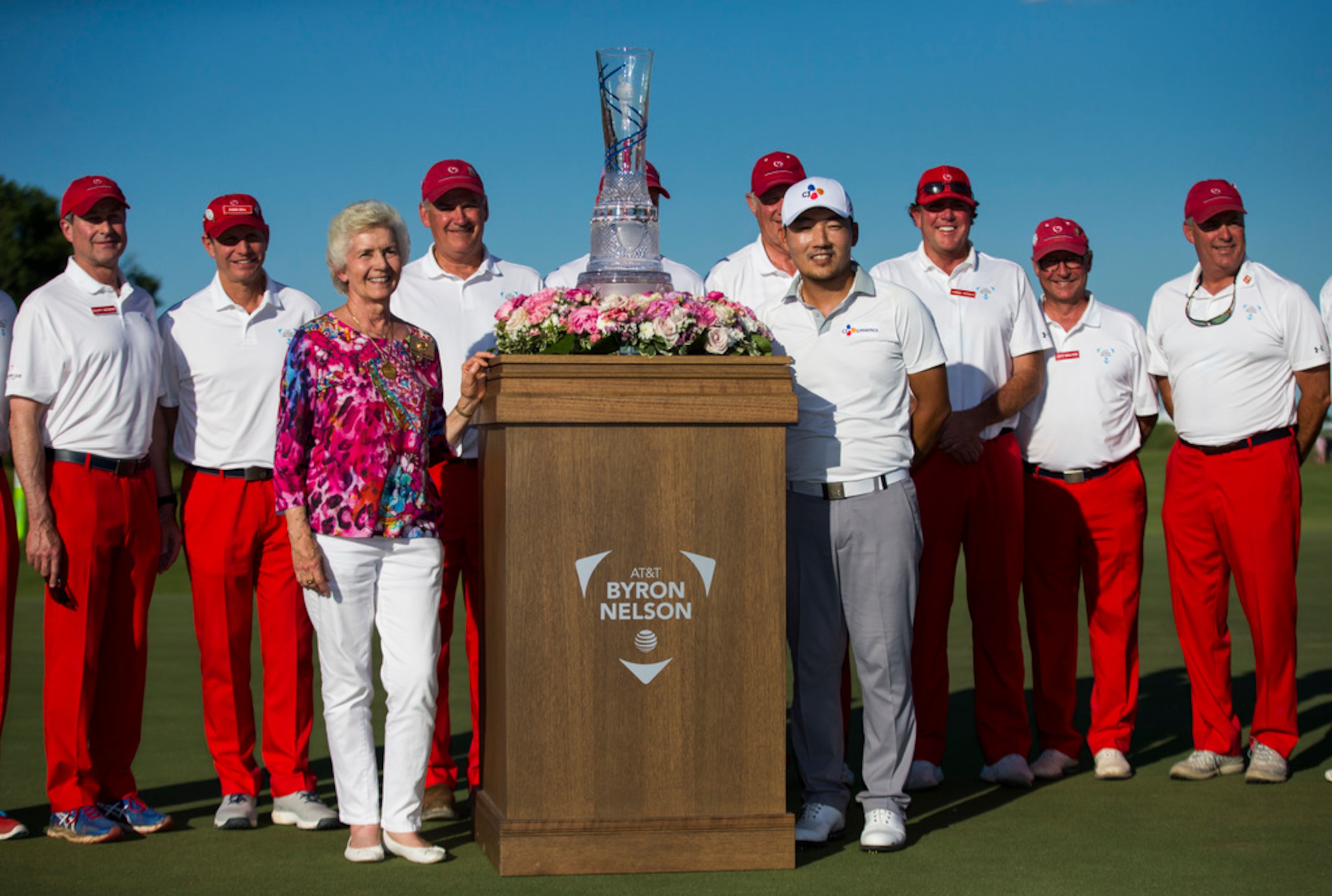 Peggy Nelson, wife of Byron Nelson, and Sung Kang pose with the AT&T Byron Nelson trophy and...