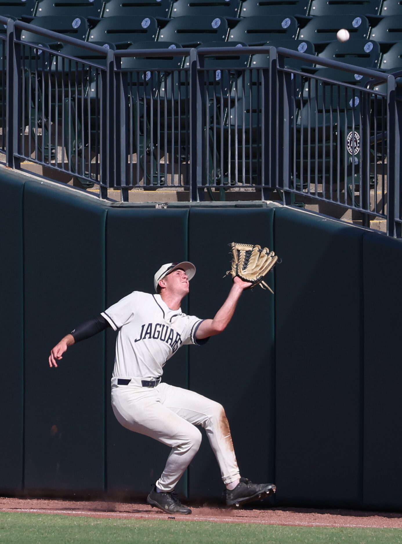 Flower Mound right fielder Garrett Wallace (1) tracks and pulls in a high foul ball near the...