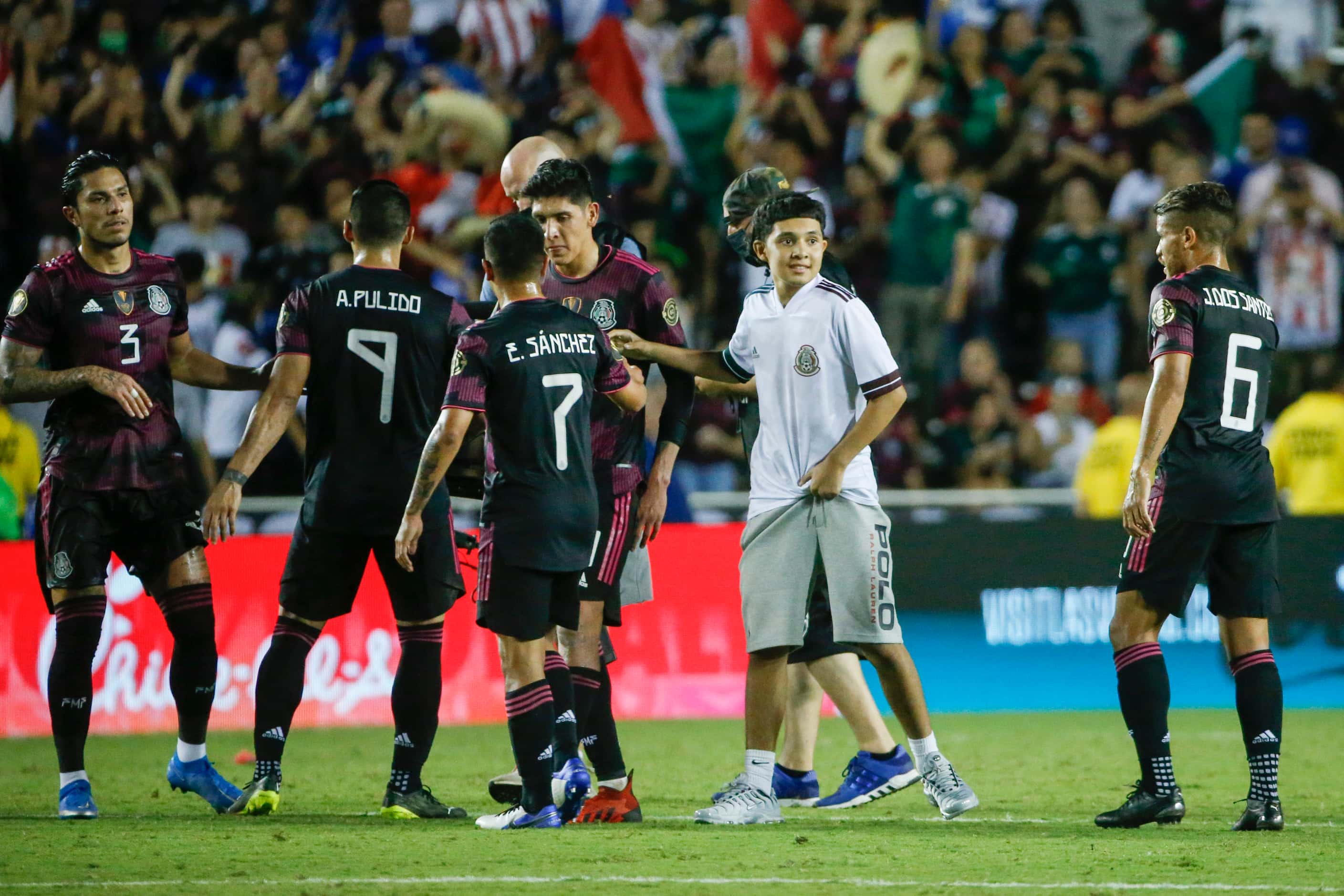 A fan on the greets Mexico players after a CONCACAF Gold Cup Group A soccer match against El...