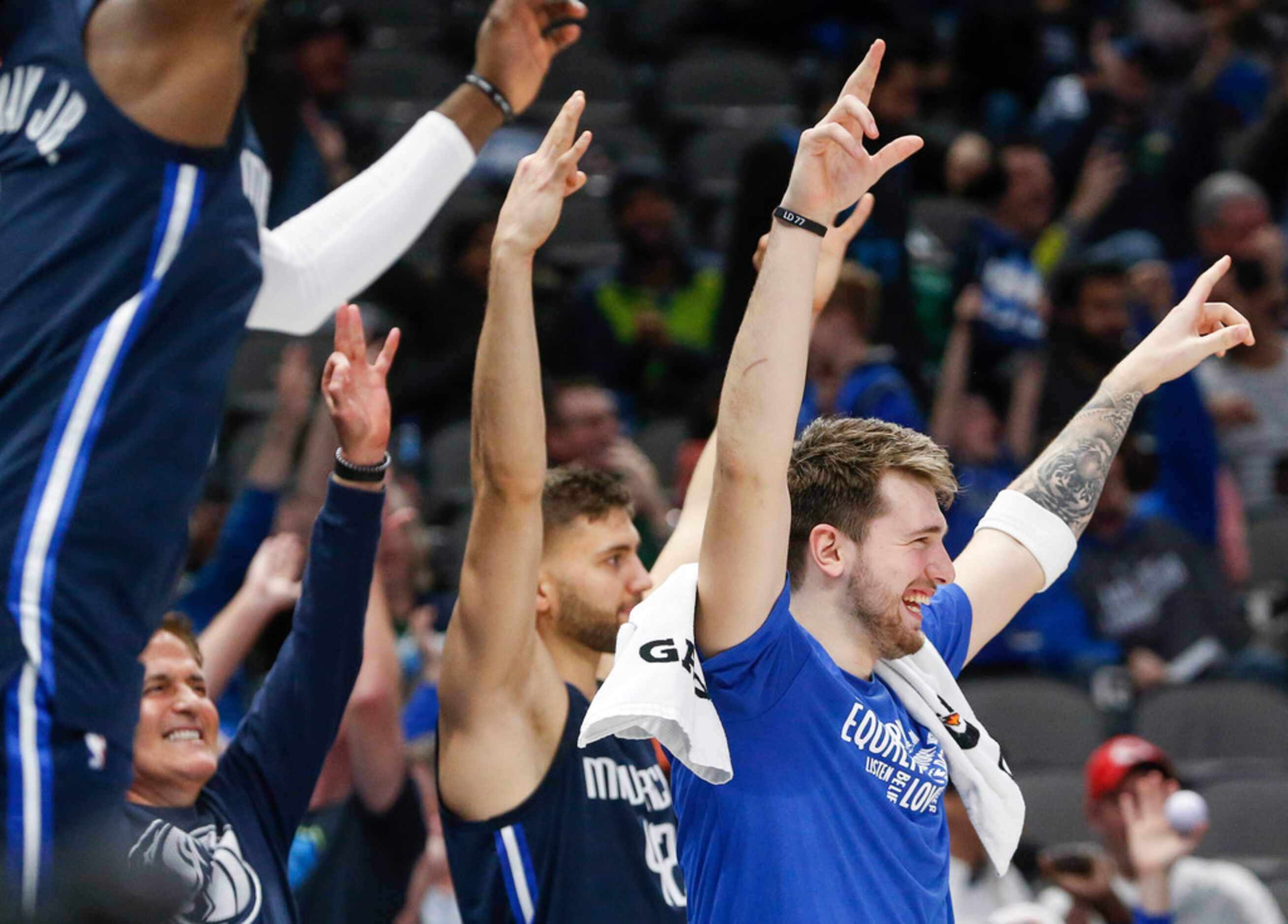 Dallas Mavericks guard Luka Doncic (77) and the bench celebrates a play during the second...