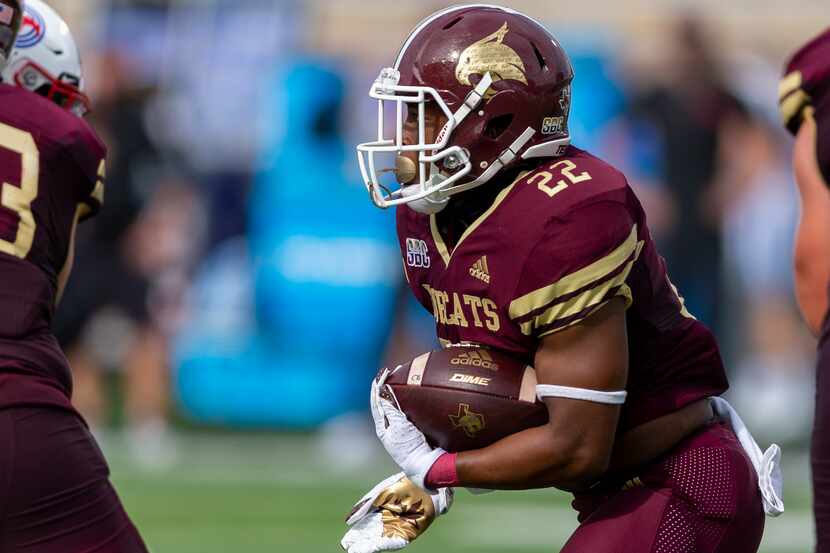 Texas State running back Calvin Hill (22) looks for running room against Southern Methodist...