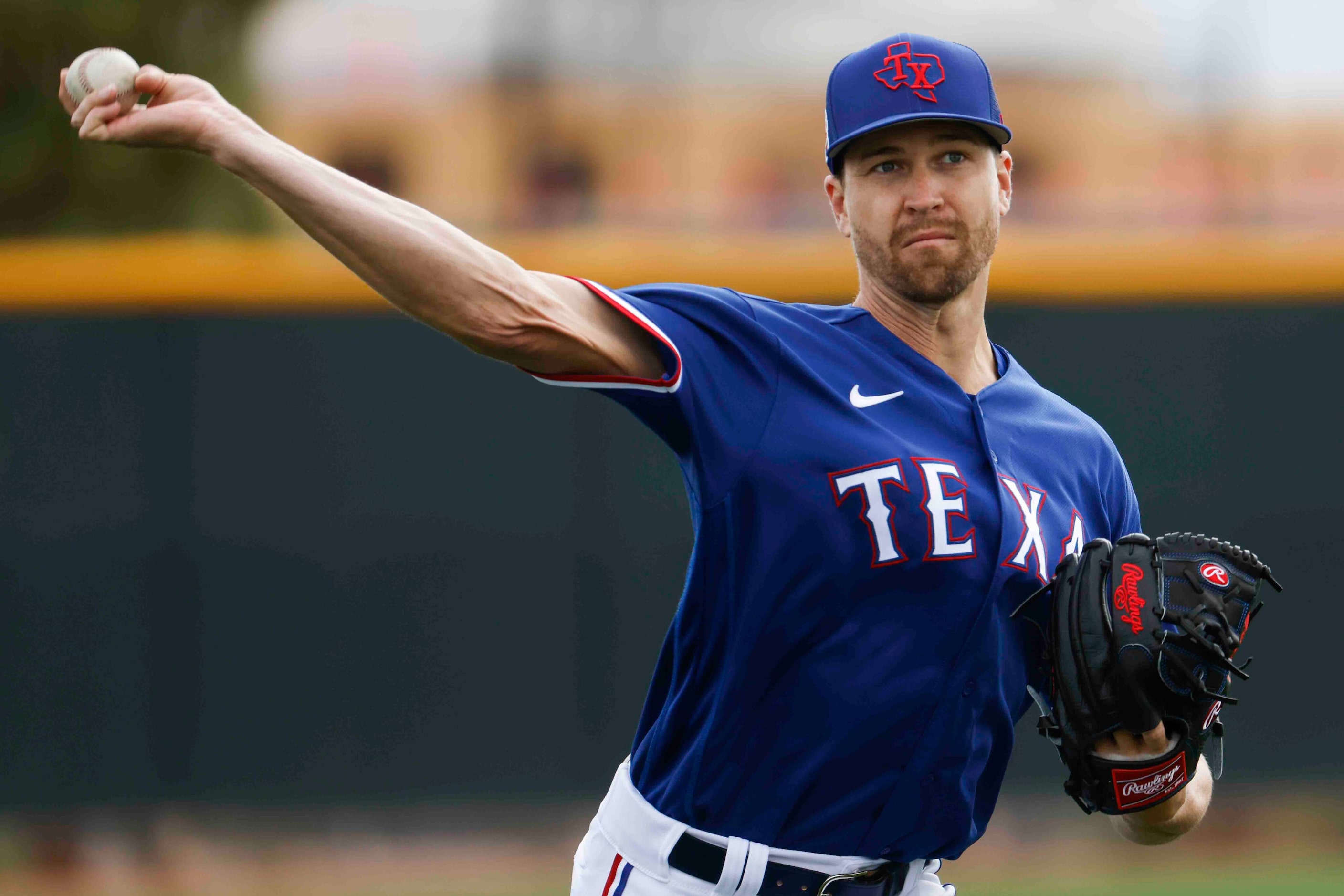 Texas Rangers pitcher Jacob deGrom throws during a spring training workout at the team's...