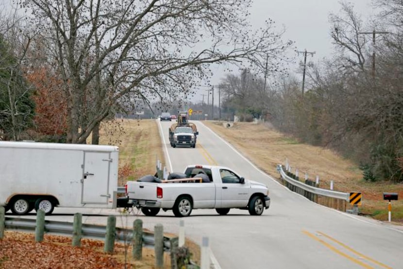 
Vehicles travel along FM1378 in Fairview. The road has taken a beating as the towns along...