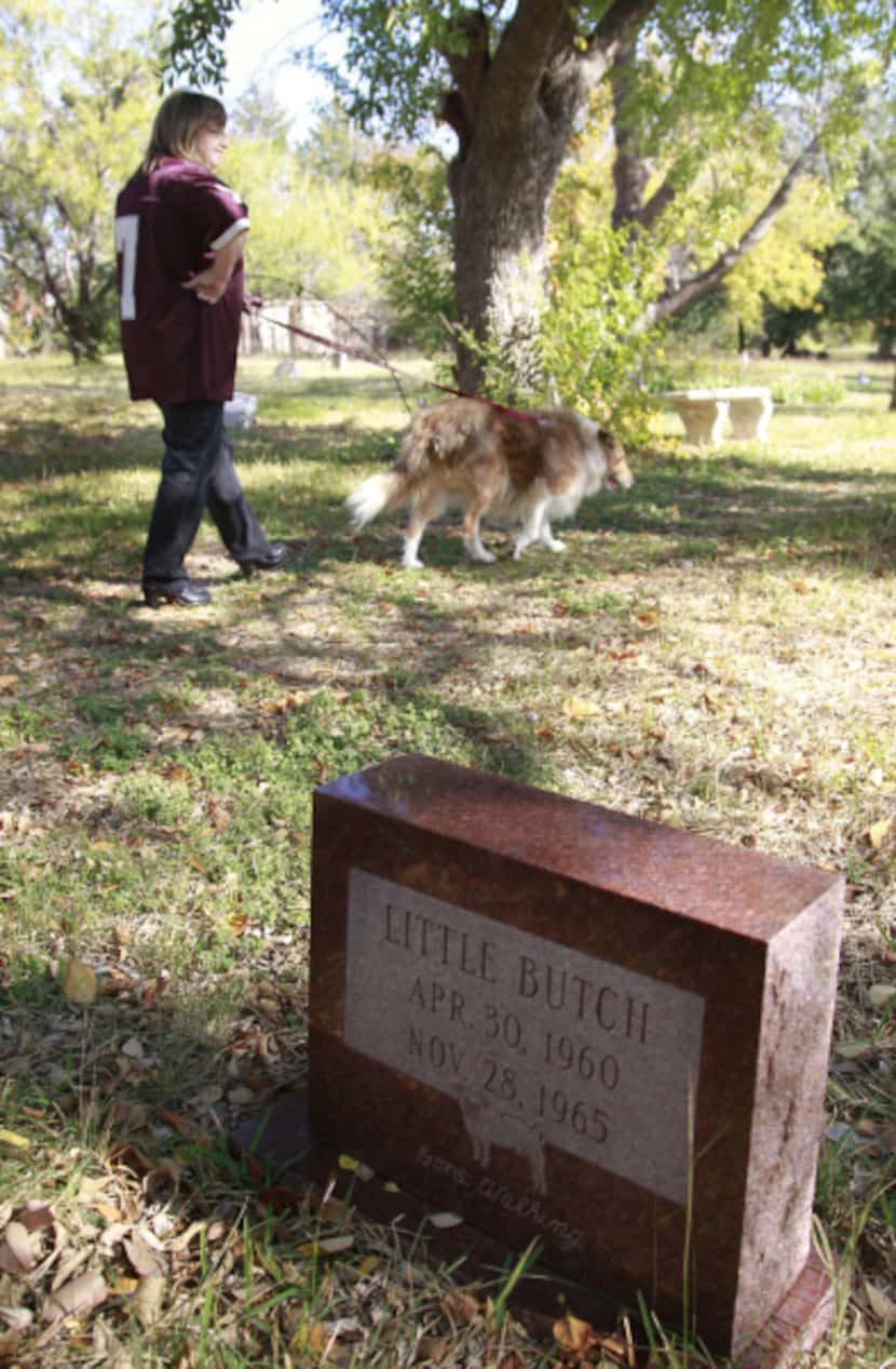 Elizabeth Haley walks her dog Lucy through the Pet Memorial Park in Cedar Hill.