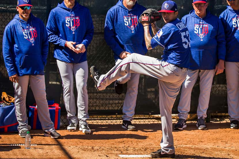 Rangers bullpen coach Hector Ortiz (from left), pitcher Jake Diekman, pitching coach Doug...