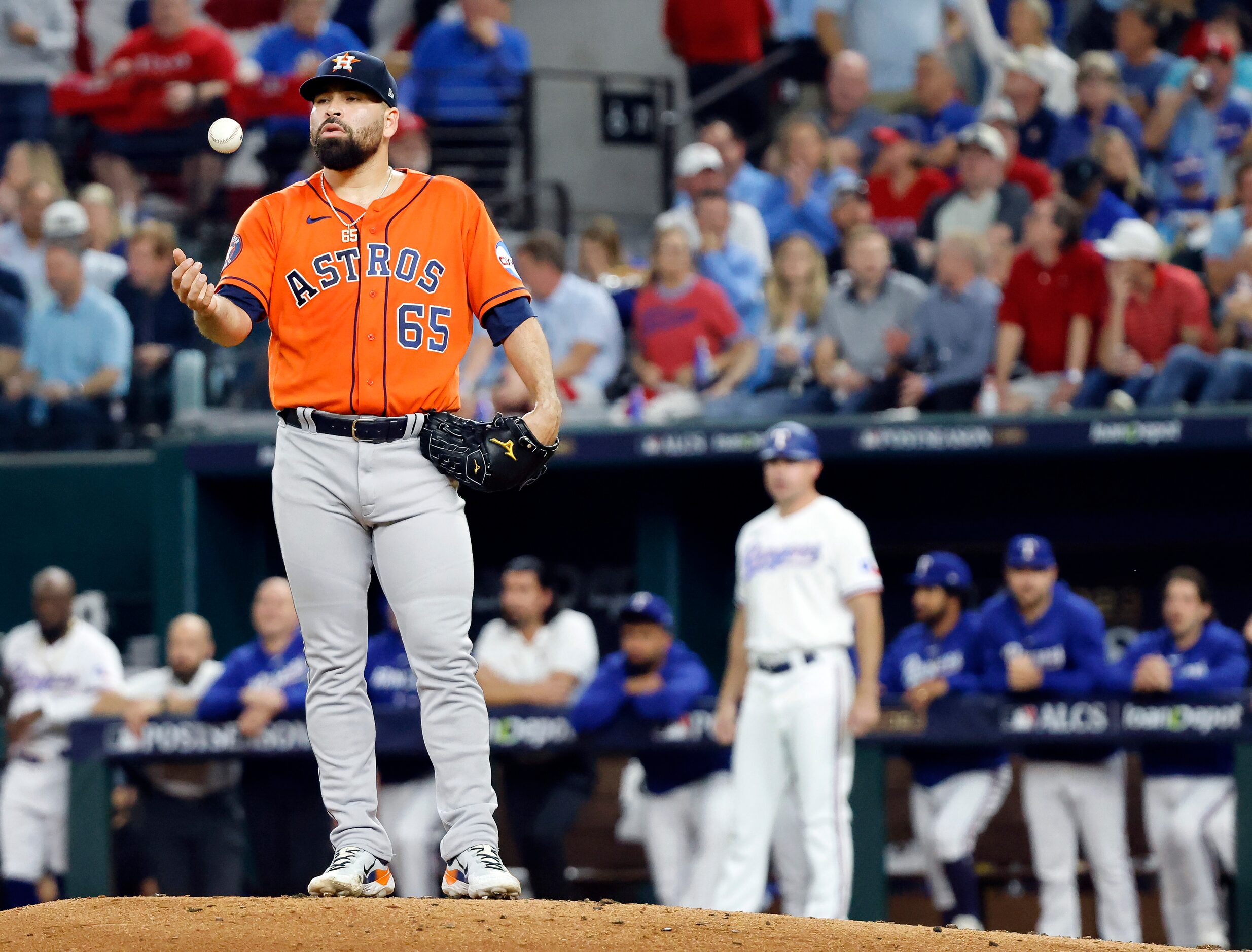 Houston Astros starting pitcher Jose Urquidy (65) tosses the ball after allowing Texas...