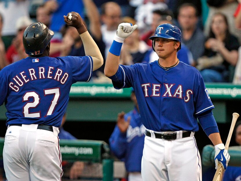 Rangers DH Vladimir Guerrero (left) is greeted at the Rangers dugout by new Rangers first...