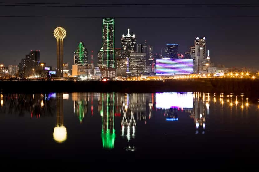 The Dallas skyline is reflected in the Trinity River.