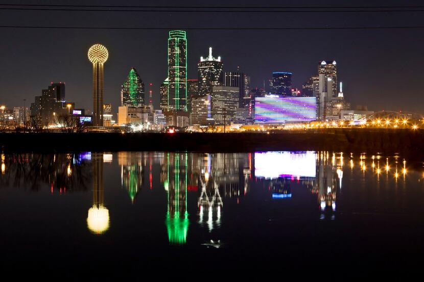 The Dallas skyline is reflected in the Trinity River.