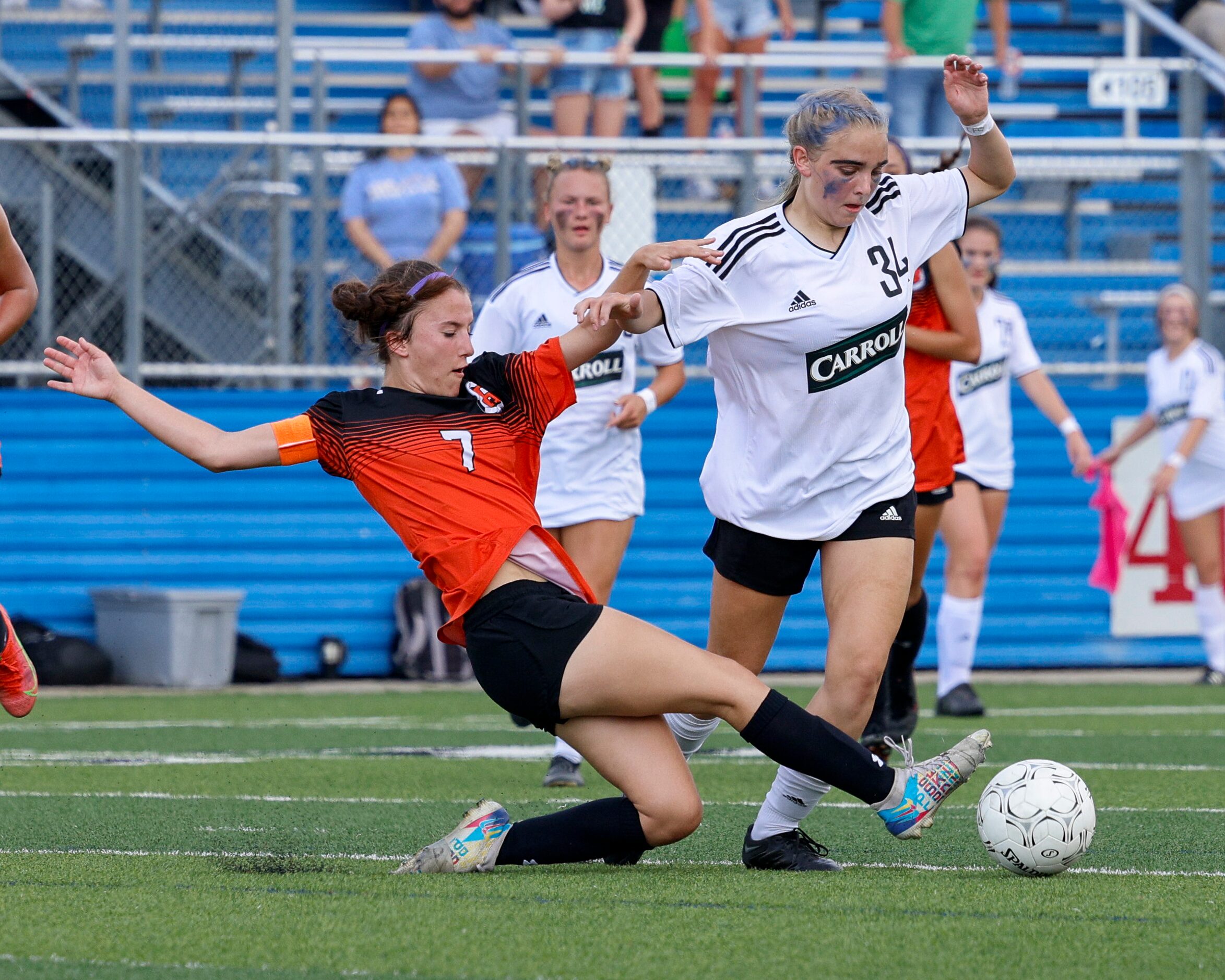 Rockwall defender Brinlee Weir (7) tackles Southlake Carroll midfielder Hannah Jordan (34)...