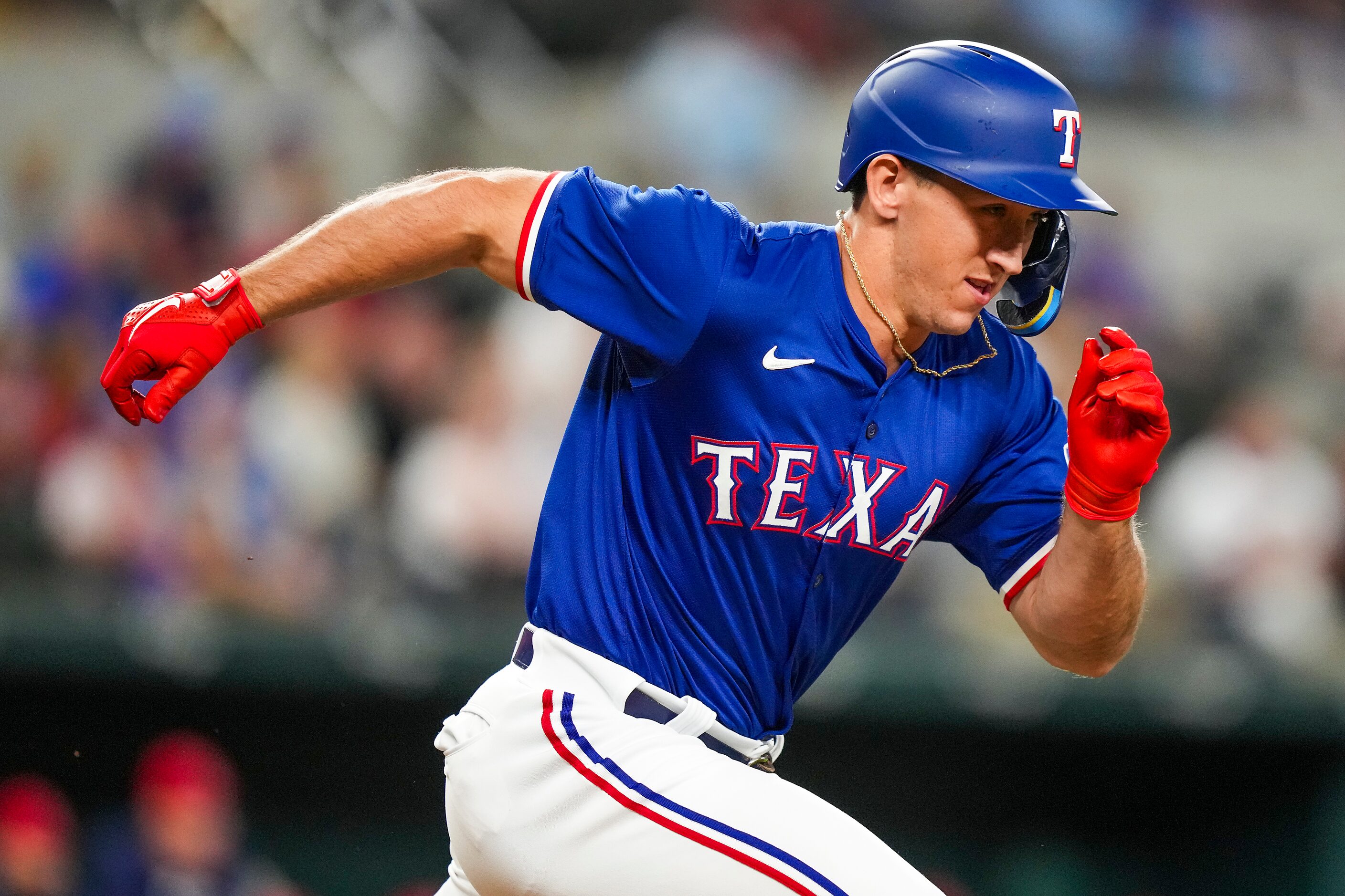 Texas Rangers designated hitter Wyatt Langford runs to first a grounder during the second...