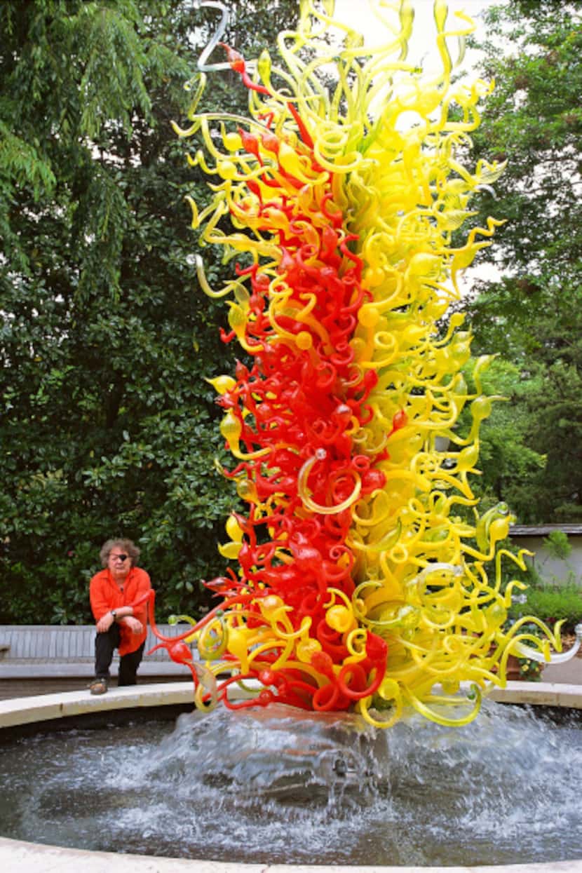 Renowned Seattle glass artist Dale Chihuly with one of his garden installations.