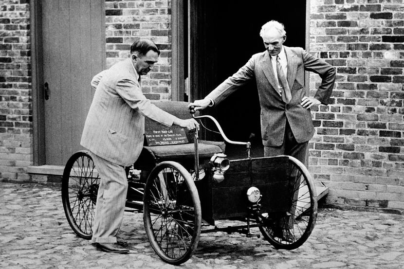 FILE - In this Dec. 10, 1936 file photo, Henry Ford, right, stands with his first car built...