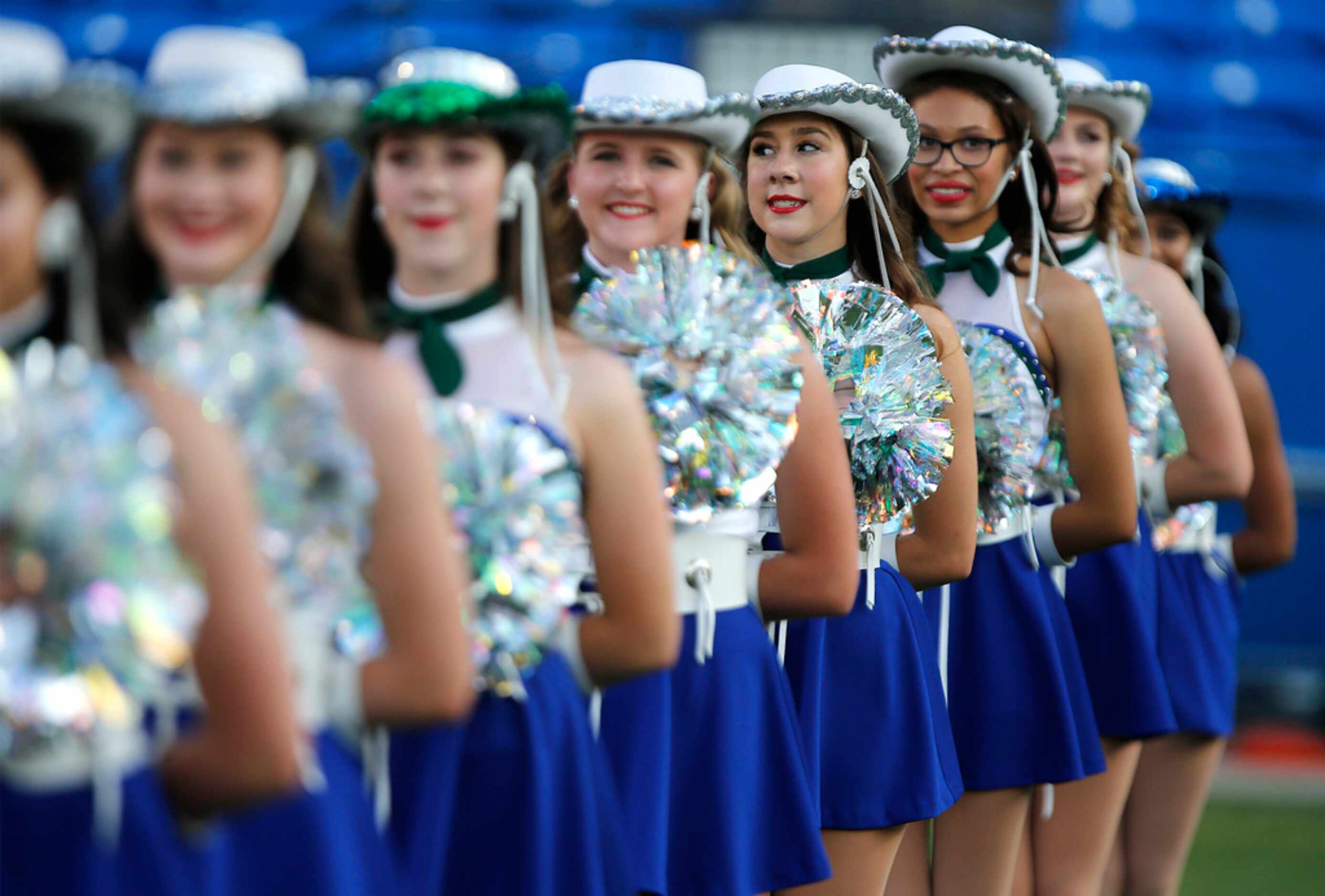 The Sapphires drill team stands at attention for Reedy High School as they hosted Plano West...