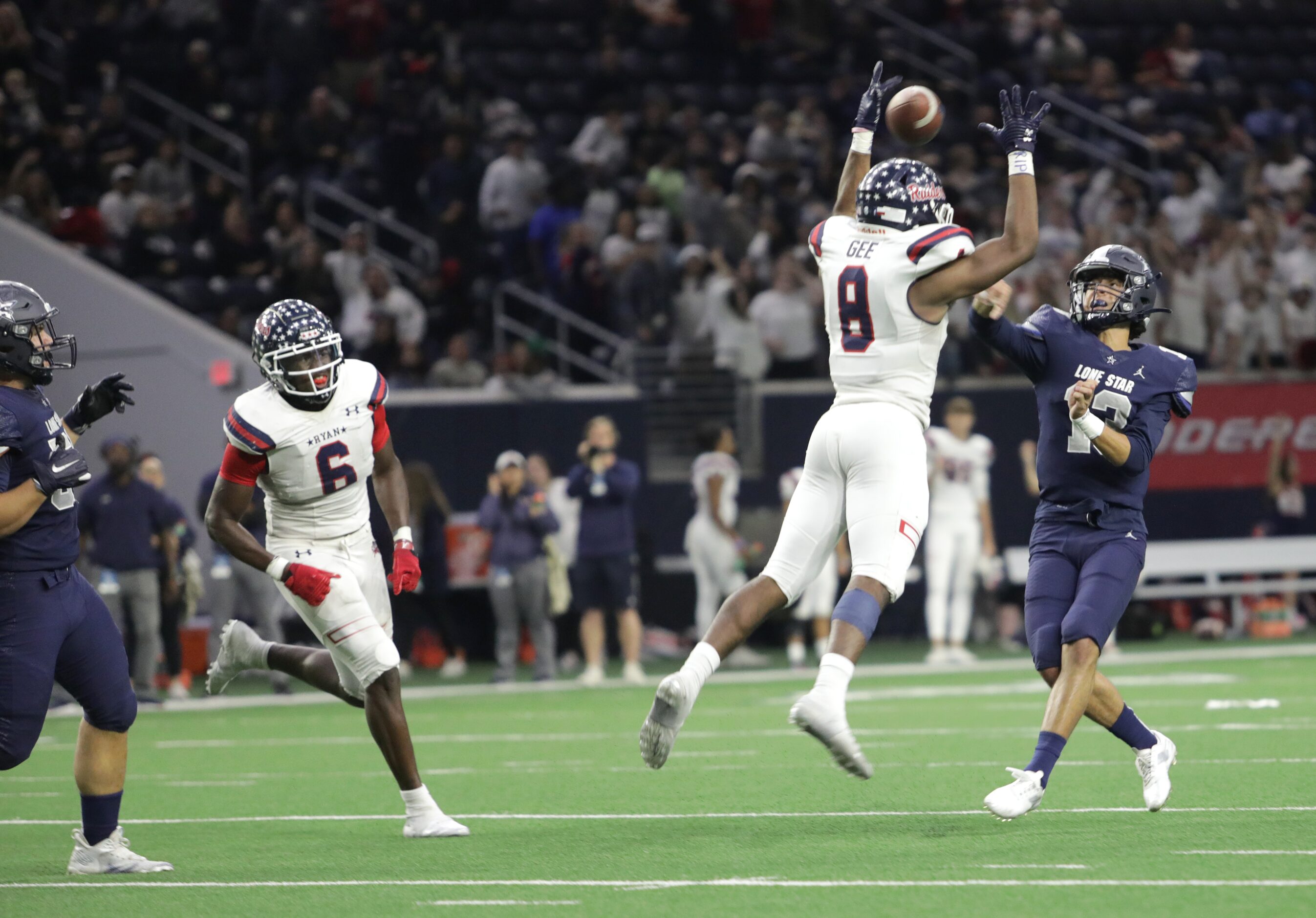 Lone Star player #13, Garret Rangel, attempts to throw the ball past Ryan player #8, Michael...