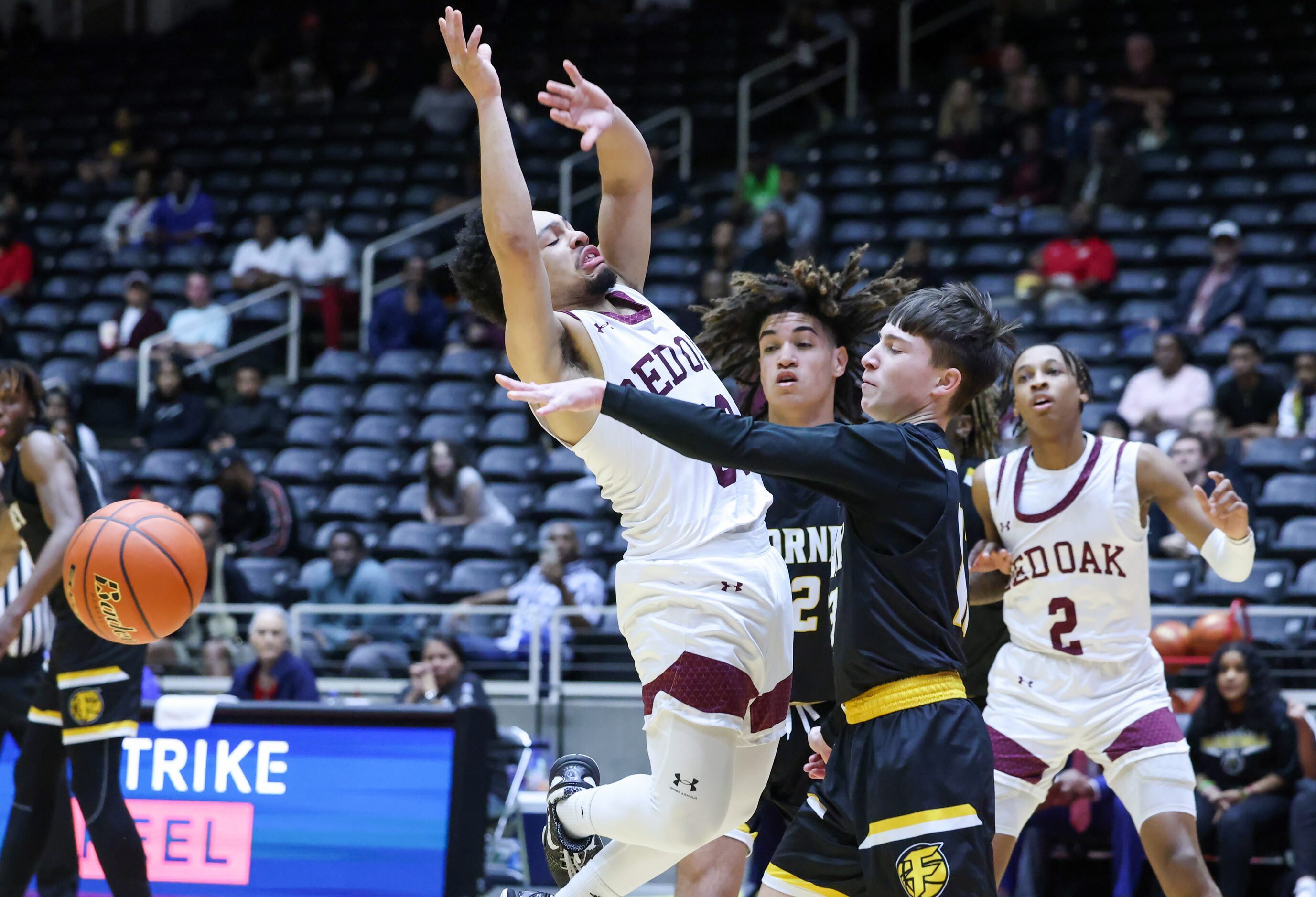 Red Oak senior guard Mark Broussard (00, left) jumps in front of a pass from Forney junior...