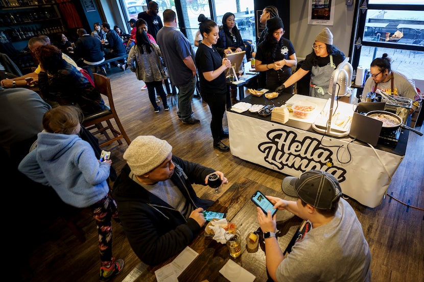 Chef Sarah Ranola (top center, with hat) works at a pop-up location of Hella Lumpia,...