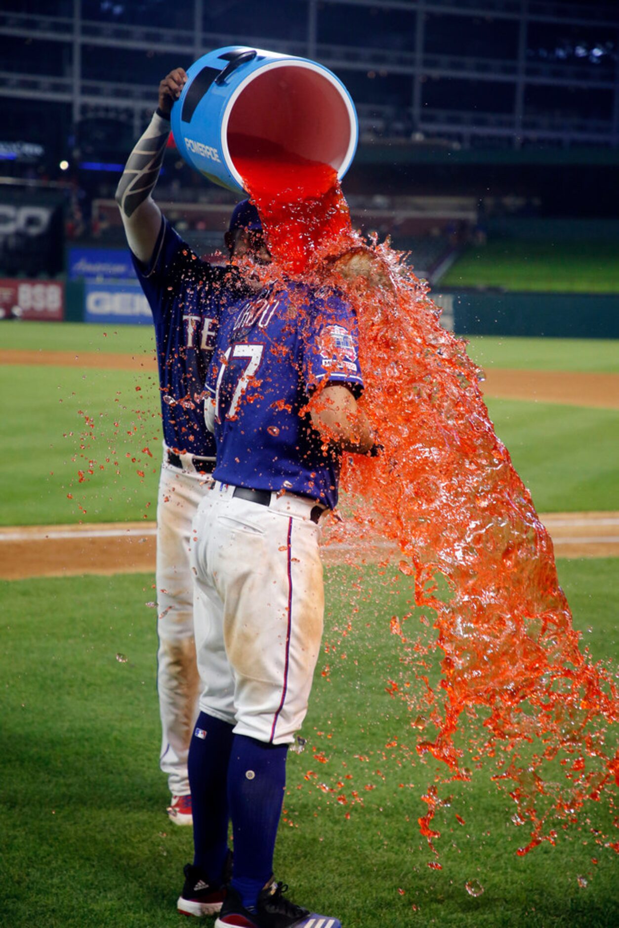 Texas Rangers' Elvis Andrus (1) douses Shin-Soo Choo (17) with a sports drink after the...