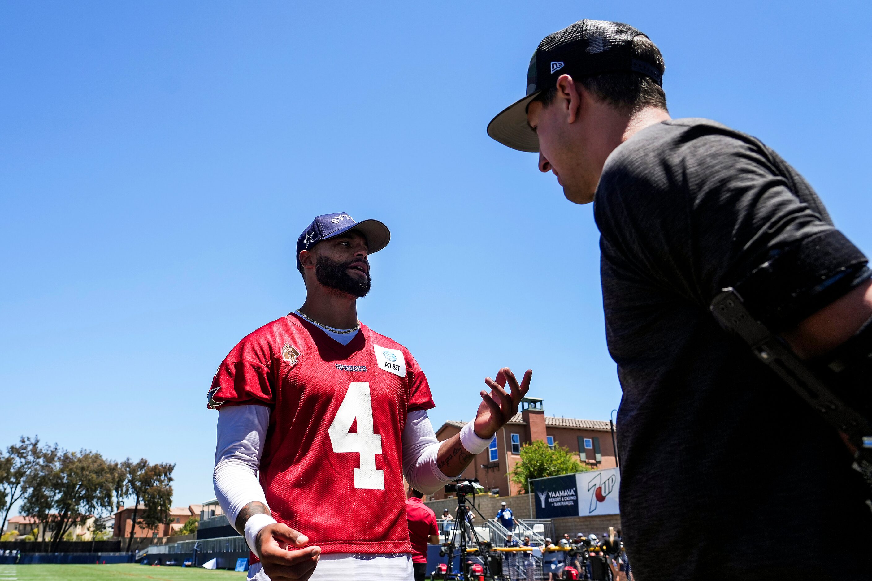 Dallas Cowboys quarterback Dak Prescott (4) chats with former Texas Rangers pitcher Derek...