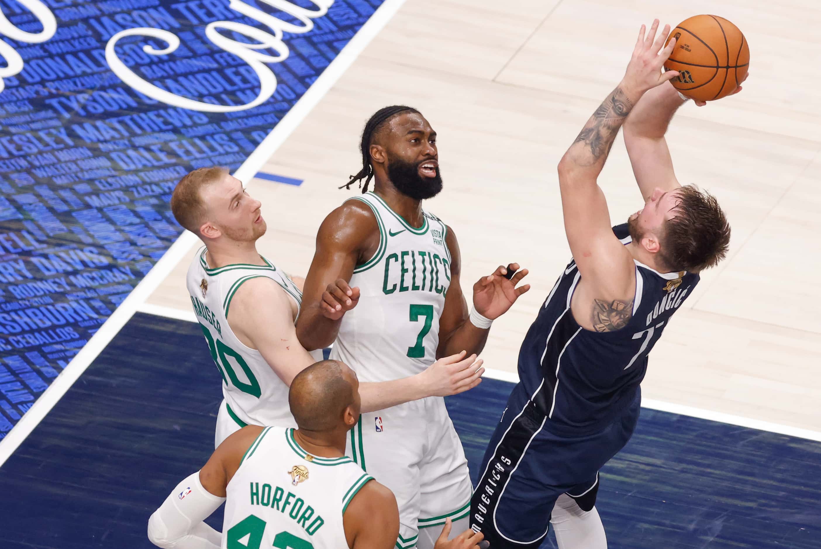 Dallas Mavericks guard Luka Doncic (77) shoots the ball Boston Celtics guard Jaylen Brown...