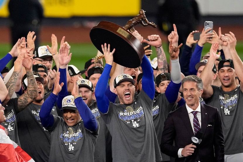 Los Angeles Dodgers' Freddie Freeman holds up the MVP trophy after the Dodgers beat the New...