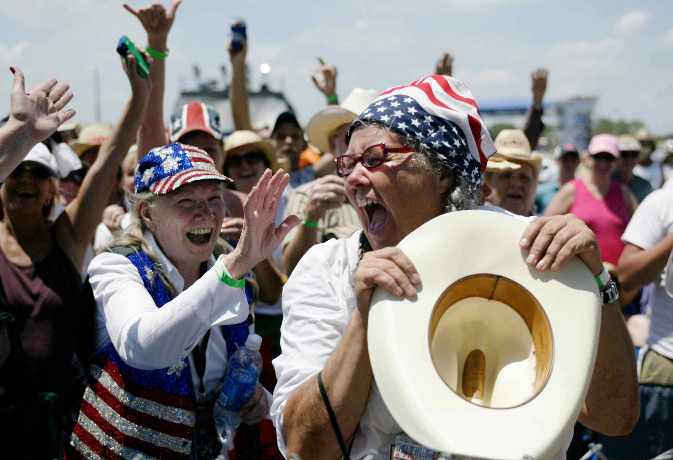 2005 - Linda Banks, of Boulder, Col., right, screams after catching Willie Nelson's cowboy...