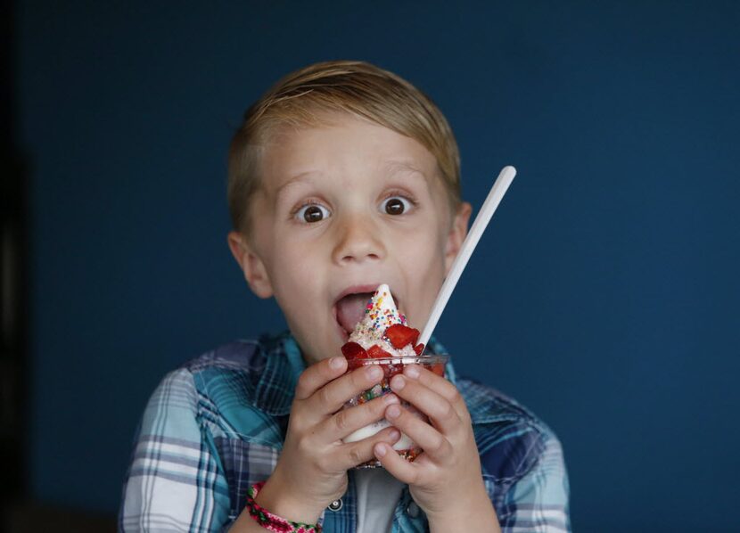 Henry McKibben eats ice cream at Cow Tipping Creamery. A new shop has opened in Carrollton.