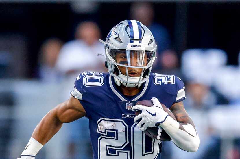 Dallas Cowboys running back Tony Pollard (20) runs the ball during the first half of an NFL...