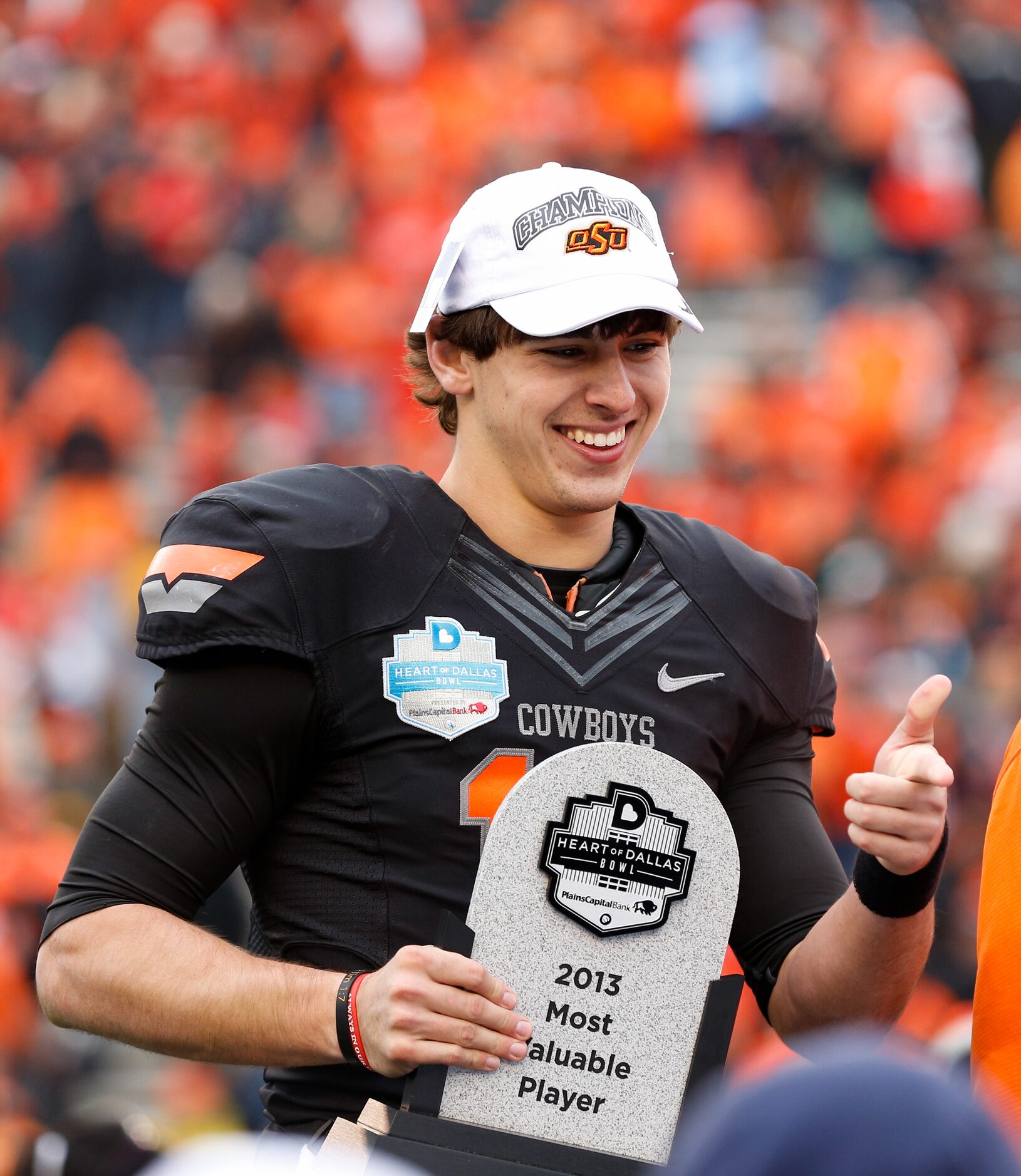 Oklahoma State's Clint Chelf (10) was awarded Most Valuable Player after beating Purdue,...