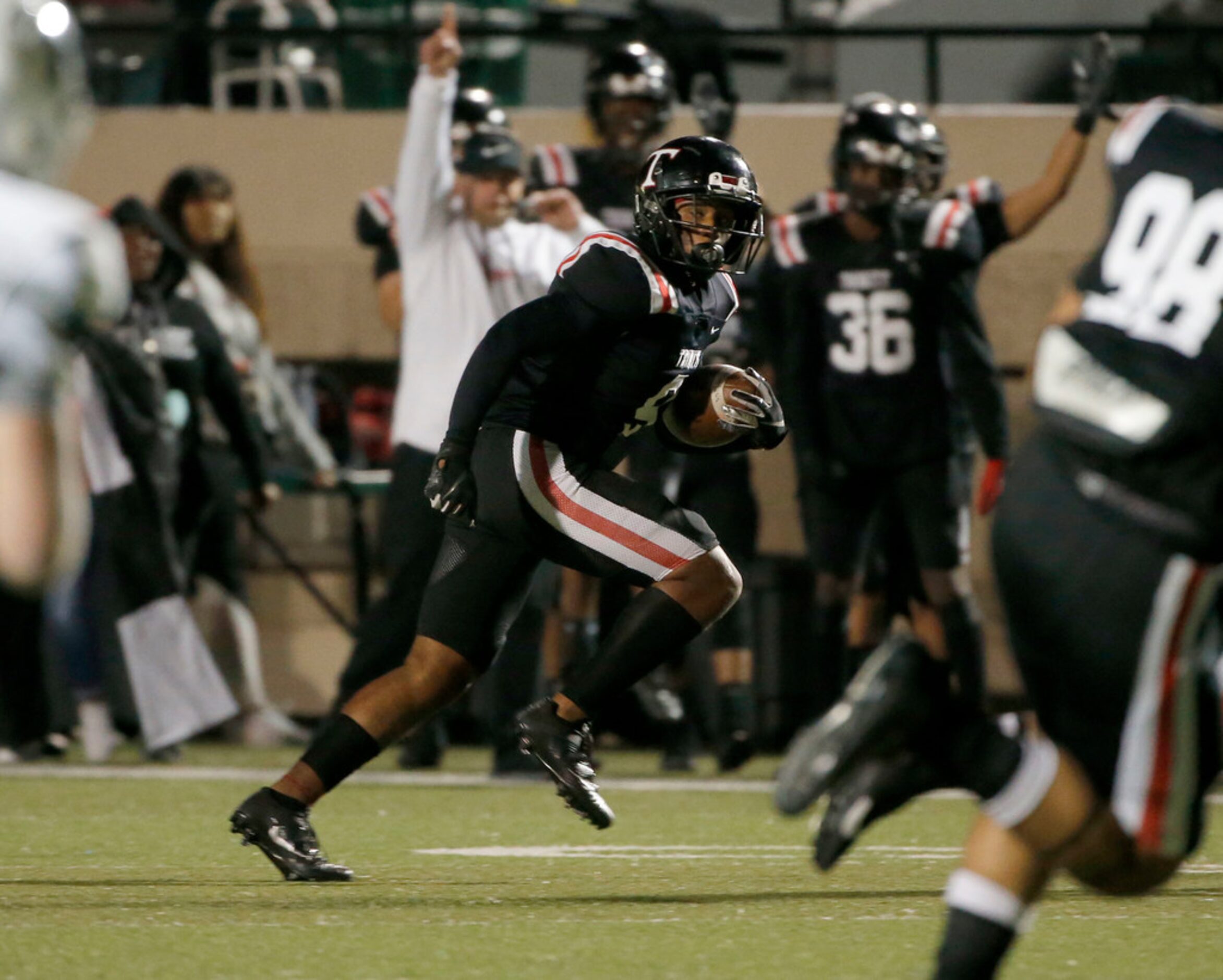 Euless Trinity's Isaiah Smith (9) runs after his interception against Richland during the...